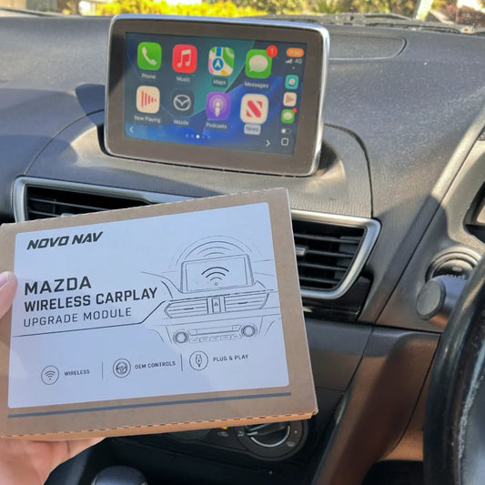 Novo Nav Mazda Connect wireless CarPlay module beside the original Mazda Connect screen